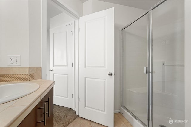 bathroom featuring backsplash, tile patterned floors, and walk in shower