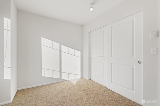 unfurnished bedroom with carpet floors and a closet