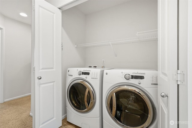 laundry room featuring washing machine and clothes dryer and light carpet