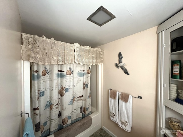 bathroom featuring shower / bath combo with shower curtain