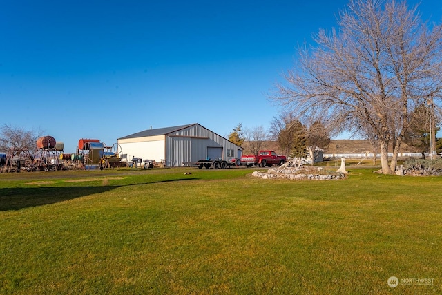 view of yard with a garage and an outdoor structure