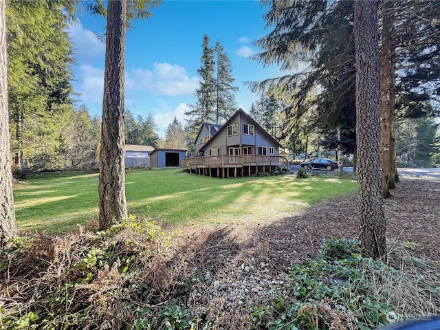 view of yard with a wooden deck and a shed