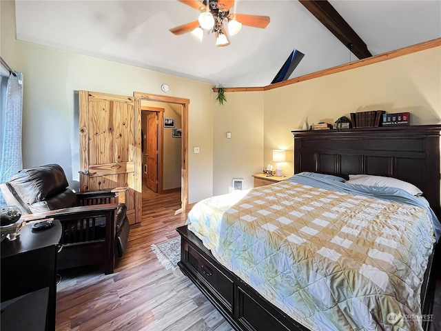 bedroom featuring hardwood / wood-style flooring, ceiling fan, and vaulted ceiling with beams