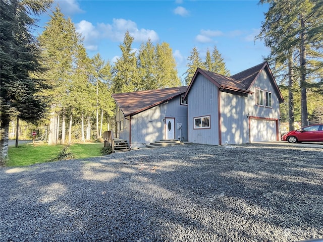 view of side of home with a garage and a lawn