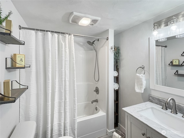 full bathroom featuring vanity, shower / bath combination with curtain, and toilet