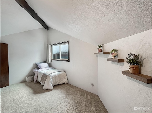 carpeted bedroom featuring lofted ceiling with beams and a textured ceiling