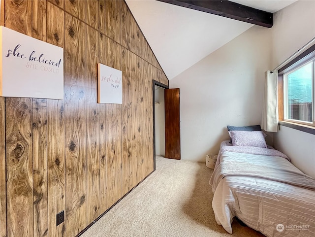 bedroom featuring vaulted ceiling with beams, wood walls, and carpet flooring