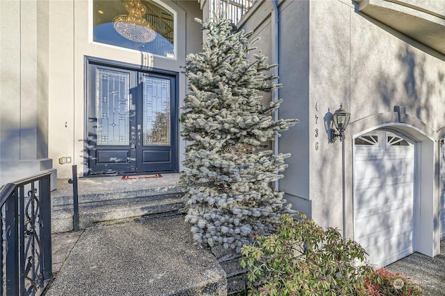 doorway to property featuring a garage and french doors