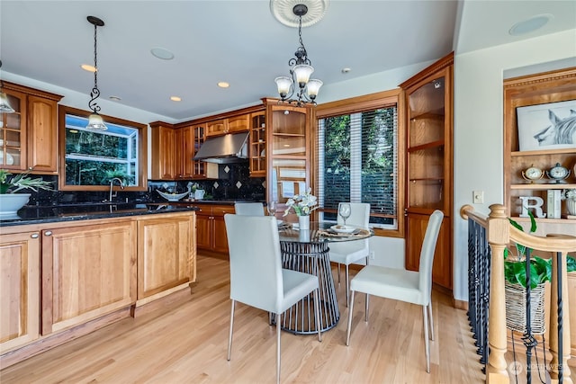 kitchen with pendant lighting, tasteful backsplash, and light wood-type flooring