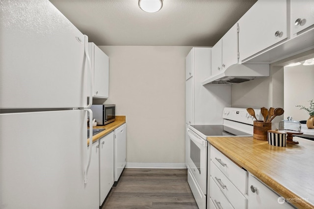 kitchen with white appliances, dark hardwood / wood-style flooring, a textured ceiling, and white cabinets