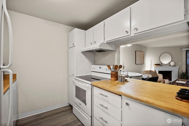 kitchen featuring white electric stove, white cabinetry, a brick fireplace, and dark hardwood / wood-style floors