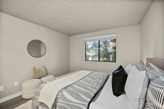 bedroom featuring hardwood / wood-style floors and a textured ceiling