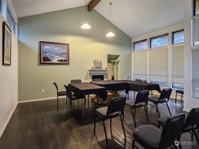 dining space with beamed ceiling, dark wood-type flooring, and high vaulted ceiling