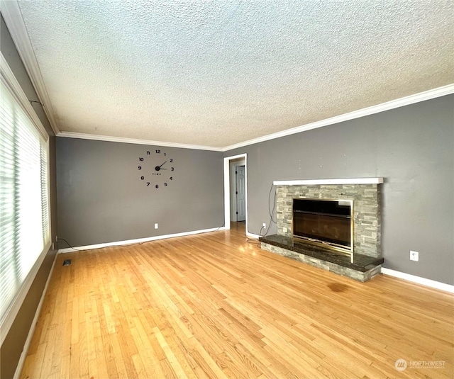 unfurnished living room with a fireplace, ornamental molding, hardwood / wood-style flooring, and a textured ceiling