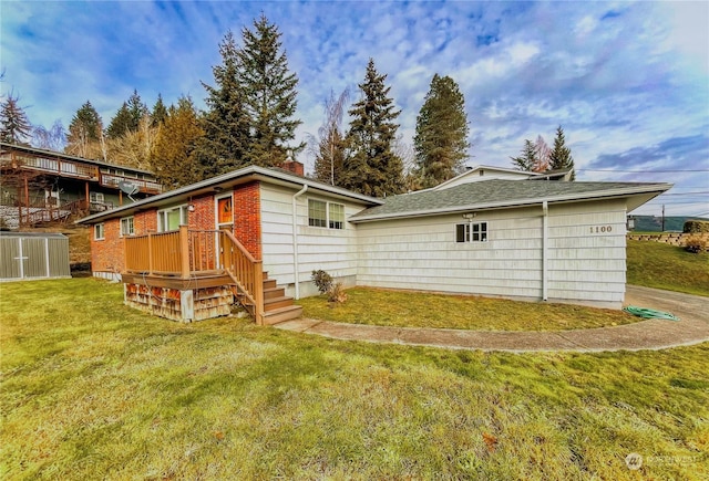 rear view of property with a lawn