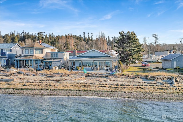 back of house featuring a water view