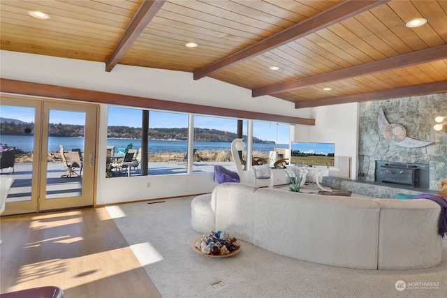 carpeted living room featuring vaulted ceiling with beams and wooden ceiling