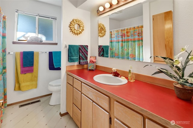 bathroom featuring vanity and toilet