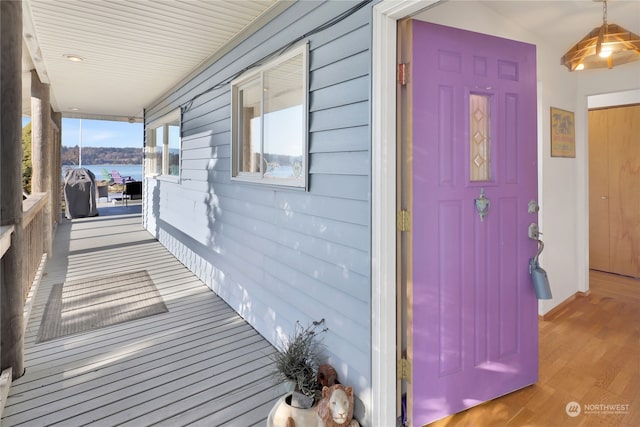 view of side of property featuring a porch and a water view