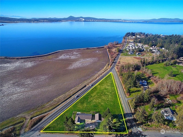 drone / aerial view featuring a water and mountain view