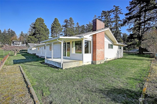 view of property exterior with a yard and a patio area