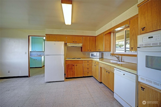 kitchen with sink and white appliances