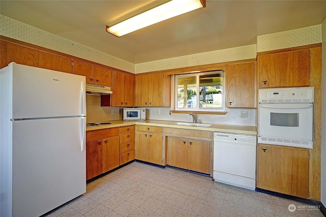 kitchen featuring sink and white appliances