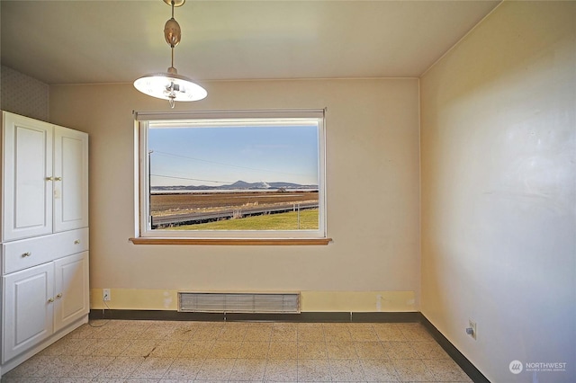 spare room featuring a mountain view