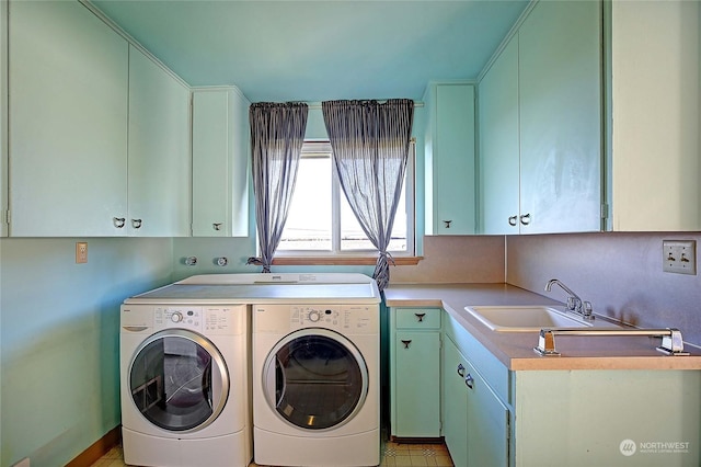 laundry area with sink, cabinets, and independent washer and dryer