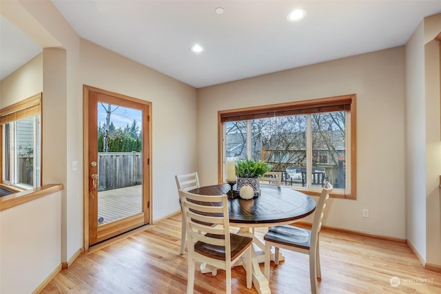 dining space with light hardwood / wood-style flooring