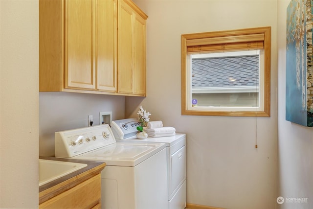 washroom with washing machine and dryer and cabinets