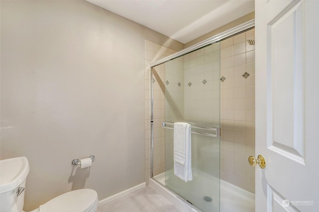 bathroom with toilet and walk in shower