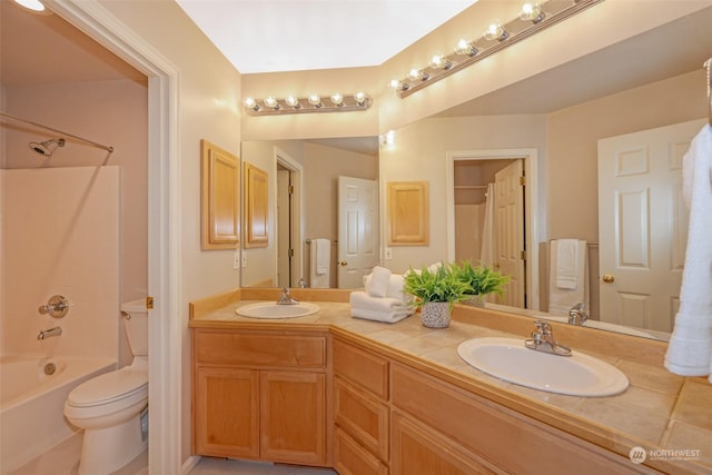 full bathroom featuring toilet, vanity, and bathtub / shower combination