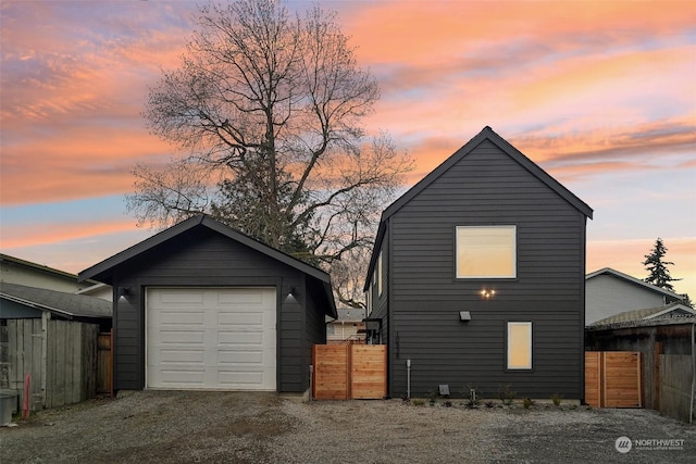 exterior space with a garage and an outbuilding