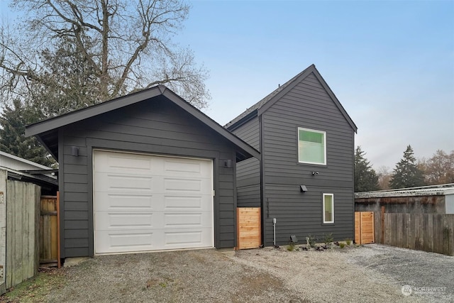 back of house with an outbuilding and a garage