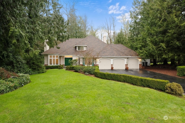 view of front of house with a garage and a front yard