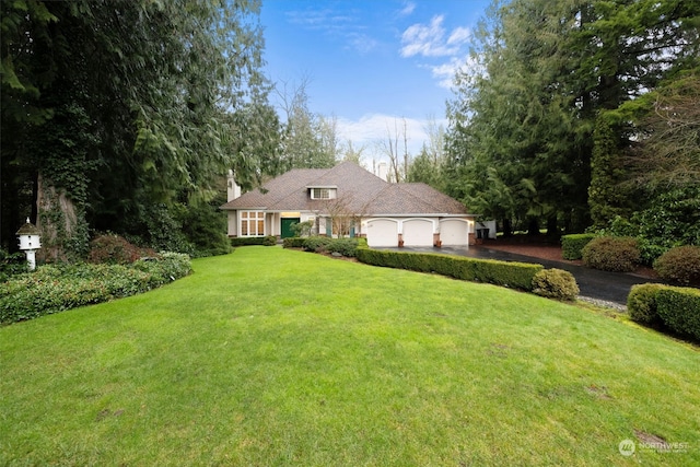 view of front of property with a front yard, driveway, and an attached garage