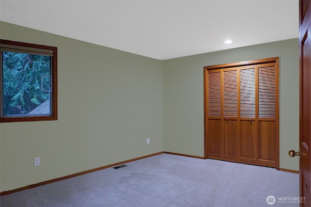 unfurnished bedroom with recessed lighting, a closet, visible vents, carpet flooring, and baseboards