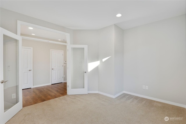 carpeted spare room with french doors