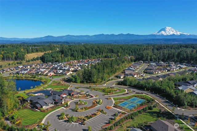 drone / aerial view featuring a water and mountain view