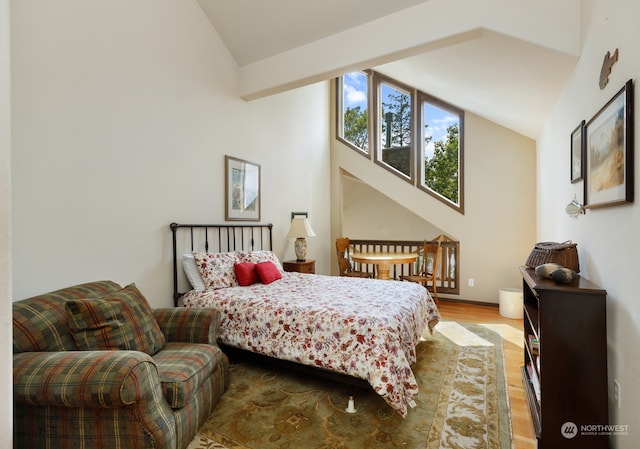 bedroom featuring vaulted ceiling and light hardwood / wood-style flooring