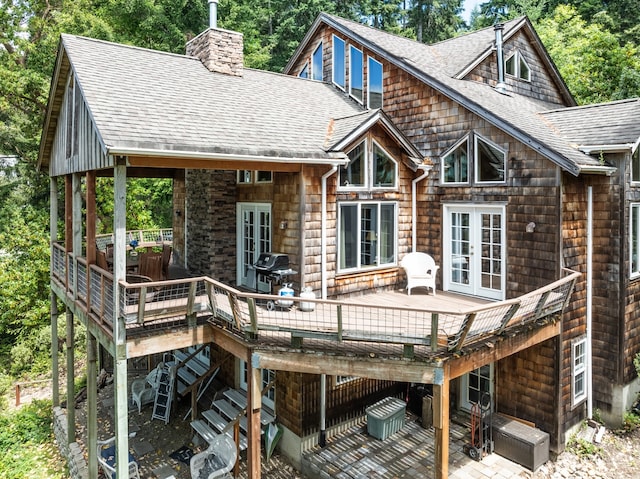 rear view of house featuring french doors and a wooden deck