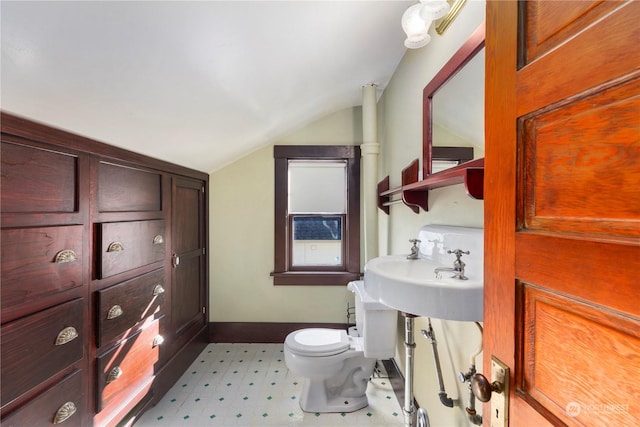 bathroom featuring lofted ceiling, sink, and toilet