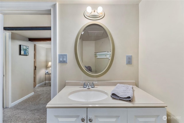 bathroom featuring vanity, beamed ceiling, and a chandelier