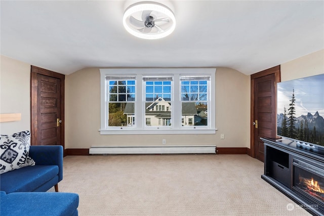 living room featuring light carpet, a baseboard heating unit, and lofted ceiling