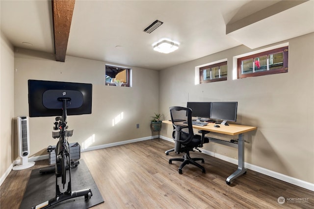 office area with hardwood / wood-style flooring and beamed ceiling