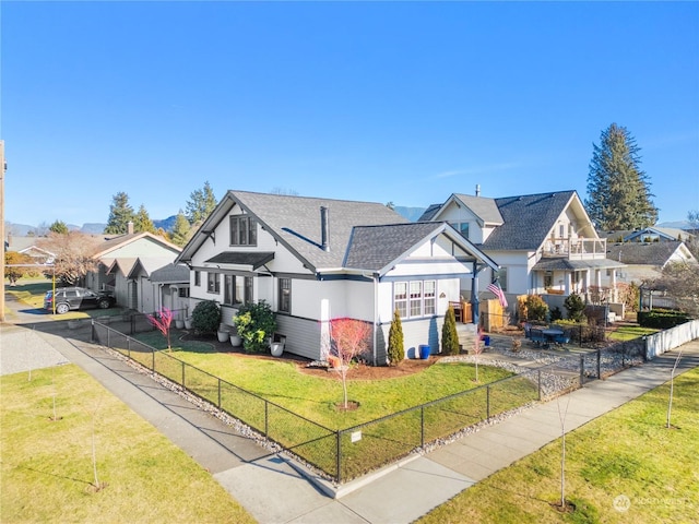 view of front of property with a balcony and a front yard