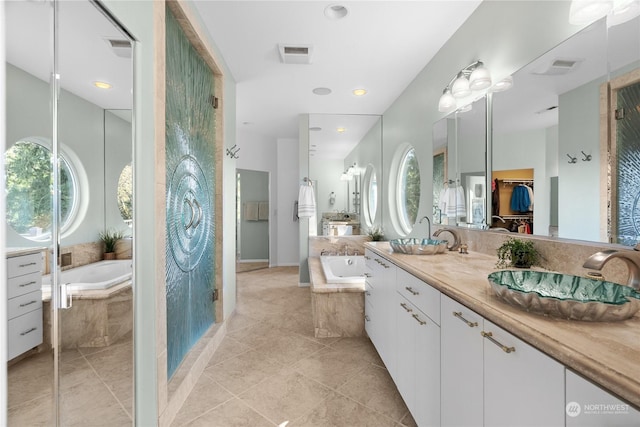 bathroom featuring tile patterned floors, vanity, and plus walk in shower