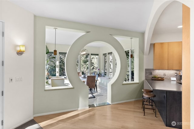 foyer with a chandelier and light hardwood / wood-style flooring