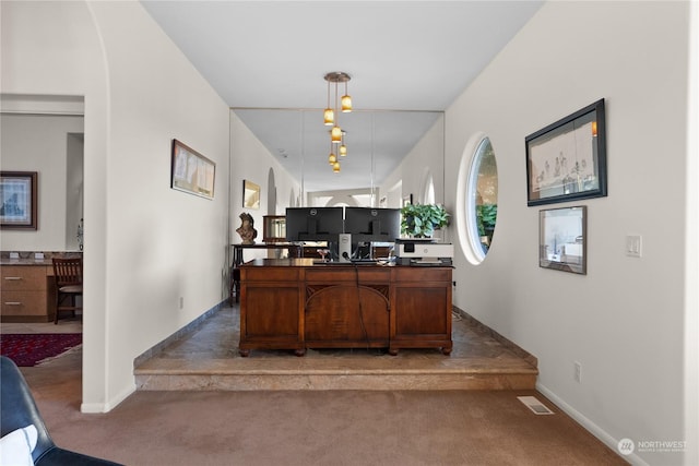 bar featuring decorative light fixtures and dark carpet